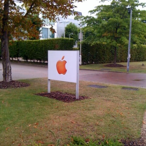 An Apple sign outside an Apple office